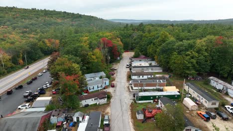 Aerial-shot-of-trailer-park-nestled-among-fall-forest-foliage-in-the-American-northeast
