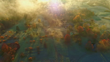 Drone-flyover-above-clouds,-Beautiful-countryside-landscape-with-Autumnal-colors,-Mystic-morning-light