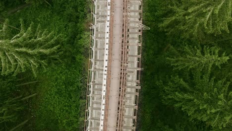 Lowering-top-down-aerial-shot-of-the-train-tracks-on-Ziemes-Valley-Bridge-