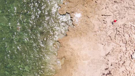 90-degree-above-drone-shot-of-tropical-waters-with-rocky-edges