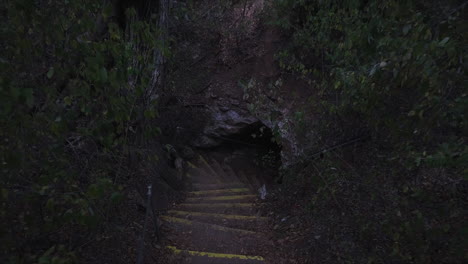 Tiro-Ascendente-De-Un-Dron-De-Las-Escaleras-Que-Salen-De-Una-Pequeña-Cueva-Que-Se-Abre