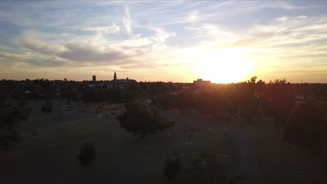 Ascending-aerial-shot-of-a-graveyard-with-the-sun-setting