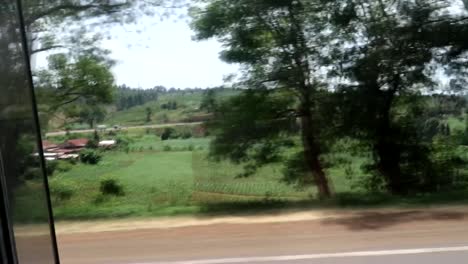 Driving-in-green-countryside-landscape-in-Nairobi,-Kenya