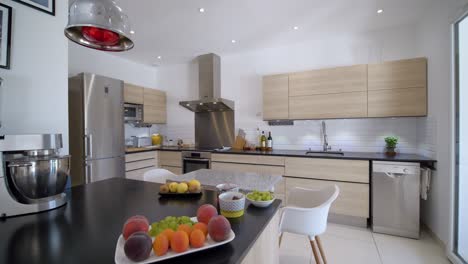 Panning-shot-of-modern-kitchen-with-fresh-fruits-on-table,close-up-shot