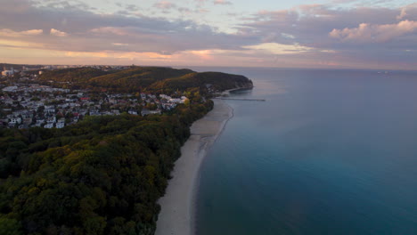 Aerial-View-Along-Tranquil-Beach-By-The-Baltic-Sea-In-Orlowo-During-Sunset
