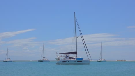 A-sailing-catamaran-motors-out-of-the-protected-bay-over-the-sandbar-at-low-tide