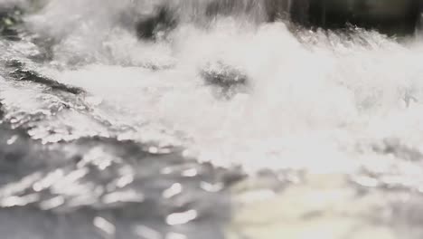 Water-Fountain-basin-with-a-heavy-waterfall-gushing-into-it-creating-splash-and-bubbles-in-Slow-Motion