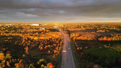 Aerial--fall-morning-light-over-a-highway-timelapse