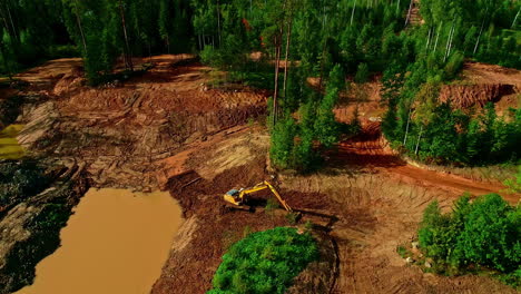 Aerial-view-of-crane-working-in-forest-area-during-sunny-day