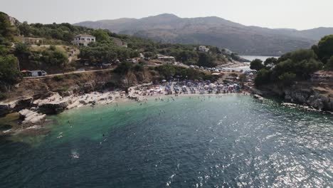 People-at-the-the-beach,-Kassiopi-fishing-village,-Corfu,-Greece