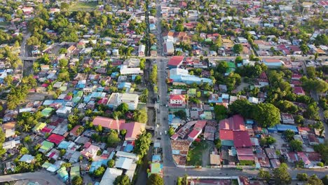 Stunning-view-of-inner-city-landscape-of-capital-Dili,-Timor-Leste-in-Southeast-Asia-with-tree-lined-streets,-traffic-commuting,-and-colorful-red-and-blue-tinned-roof-buildings