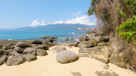 Stroll-on-the-beautiful-beach-of-Angra-dos-Reis-with-a-ship-in-the-background