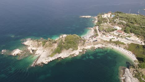 Aerial-view-of-the-island-reef-and-beach,-luxury-tourism-in-Kassiopi,-Greece