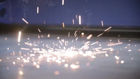Slow-motion-of-welding-sparks-hitting-the-factory-floor