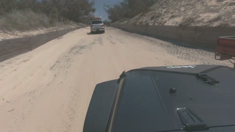 Black-jeep-drives-down-sandy-track-following-other-4X4-vehicle-through-the-bush