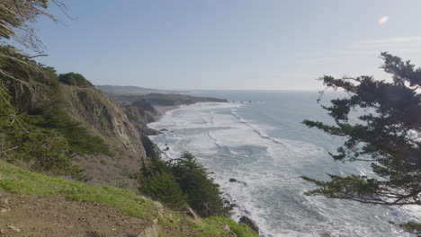 view-from-mountainside-of-Big-Sur-Beach-California-with-waves-of-the-Pacific-Ocean-rolling-in