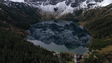 Aerial-footage-of-snowcapped-peaks-reflected-in-Morskie-Oko-Lake-in-Zakopane-Poland