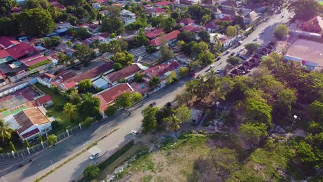 Aerial-drone-above-inner-city-fruit-and-vegetable-market-and-free-flowing-traffic-moving-about-Dili,-Timor-Leste-in-Southeast-Asia,-aerial-drone-view-of-asian-capital