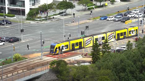 Glink-translink-urban-public-transportation,-tram-running-on-tramway-along-gold-coast-highway-towards-Broadbeach-south-station,-Queensland,-Australia