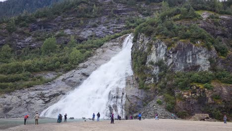 Nugget-Falls-near-Mendenhall-Glacier-in-Juneau-Alaska-with-tourists-taking-pictures