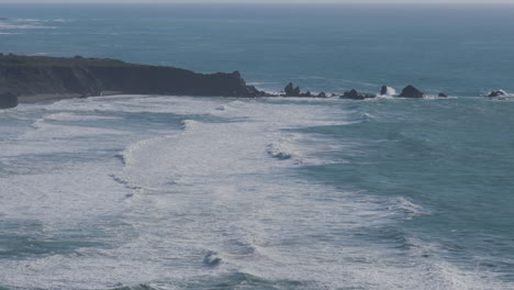 Stationary-shot-of-waves-shredding-though-the-waters-of-the-Pacific-Ocean-located-in-Big-Sur-California
