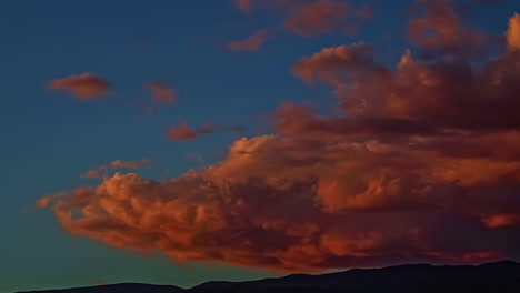Shot-of-orange-red-puffy-clouds-passing-by-blue-sky-during-evening-time-in-timelapse