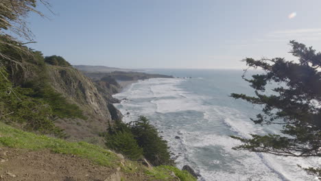 Stationary-shot-from-hill-side-with-waves-crashing-in-to-the-shore-of-Big-Sur-California-Beach