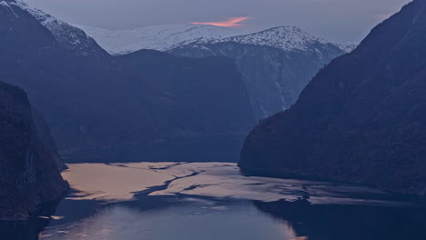 Timelapse-of-beautiful-Norwegian-landscape-of-Lovatnet-lake-changing-patterns-and-snowcapped-mountain-at-the-background