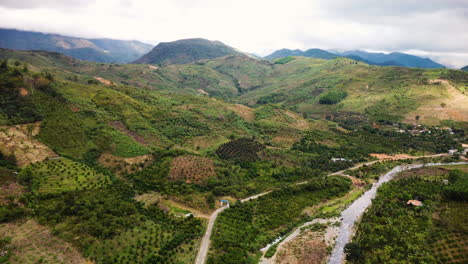 aerial-view-of-Phuoc-Binh-vietnam-rural-remote-countryside,-drone-reveal-green-valley-with-plowed-land