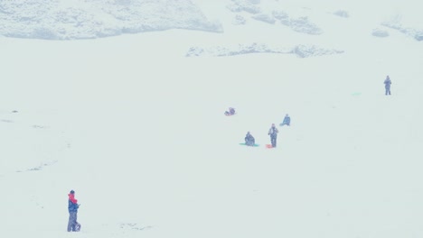 Kid-riding-their-sled-part-way-down-a-snowy-hill-and-wiping-out