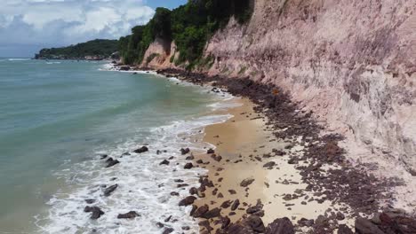High-Tide-Of-Brazilian-Beach-Side-Cliffs-and-Shallow-amounts-Of-Beach-to-Walk-On