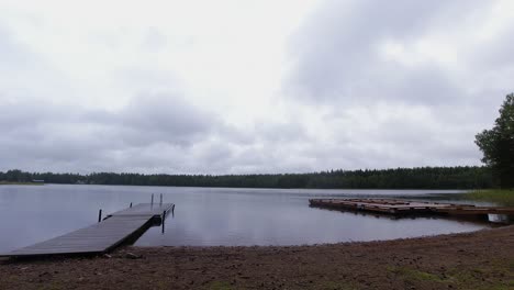 Country-background-time-lapse:-Clouds-drift-over-peaceful-forest-lake