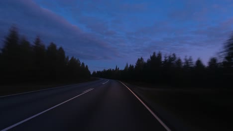 Dusk-driving-POV:-Alone-on-country-highway-during-blue-light-dusk
