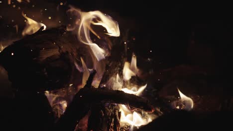 Slow-Motion-Shot-Campfire-poked-by-wooden-stick