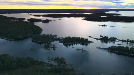 Swedish-archipelago-in-aerial-drone-shot-flying-over-water-forest-and-islands