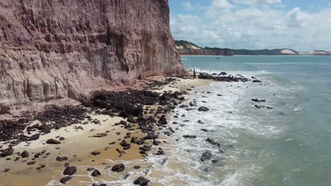 Preserve-Sign-along-Brazilian-Beaches-Pan-up-to-show-Cliffs,-Sand-And-Tropical-Forest