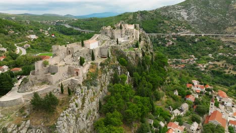 Rotating-aerial-view-of-the-front-side-of-the-fortress-of-Klis-in-Split,-Croatia