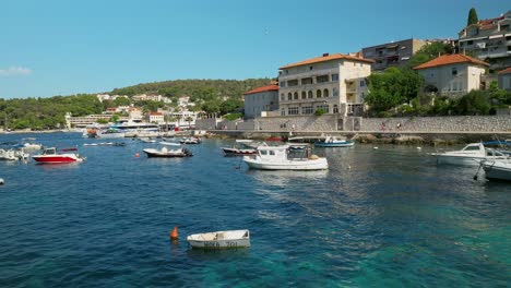 Low-aerial-approach-over-small-boats-in-Hvar,-Croatia