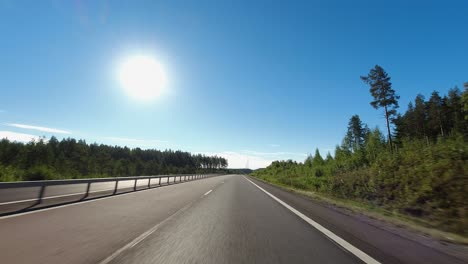 Hyperlapse-POV:-Driving-on-country-highway,-sun-ball-in-blue-sky