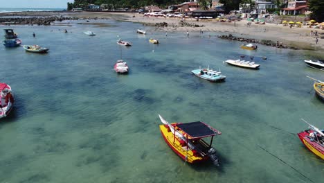 Panning-over-Small-Boats-Floating-in-a-Tide-pool-Harbor-with-Crystal-Clear-Water