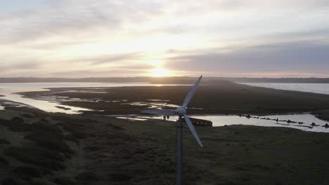 Sunrise-aerial-flies-past-wind-turbine-near-Tramore-Sandhills-dunes