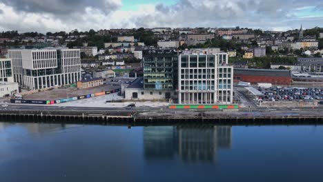 Horgans-Quay-waterfront-reflects-in-River-Lee-in-coastal-Cork,-Ireland
