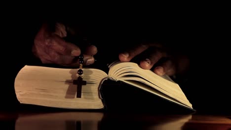 man-praying-to-god-with-hands-together-with-bible-Caribbean-man-praying-with-black-background-stock-video