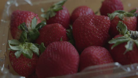 Close-Up-Pan-Right-of-Fresh-Strawberries-in-a-Container