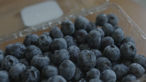 Close-Up-Tilt-Down-of-Fresh-Blueberries-in-a-Container
