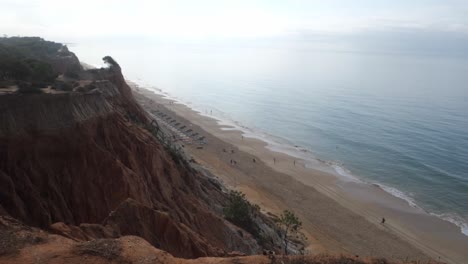 Beautiful-view-of-Falesia-beach-in-the-foggy-morning,-Stunning-Cliffs-and-touquoise-water,-Algarve