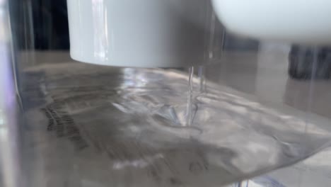 Close-up-of-clean-water-dripping-from-handheld-carbon-based-water-filter-system