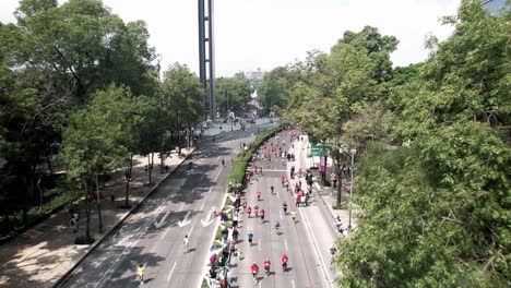 frontal-drone-shot-of-the-runners-of-the-city-marathon-as-it-passes-through-the-castle-of-chapultepec