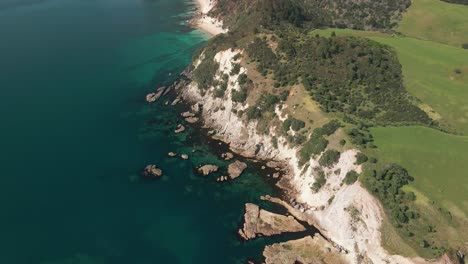 Drone-flying-over-rocky-limestone-clifftops-of-Cray-fish-bay