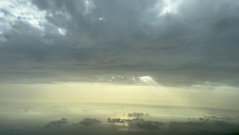 Aerial-view-of-a-dramatic-sky-with-sunbeam-through-a-hole